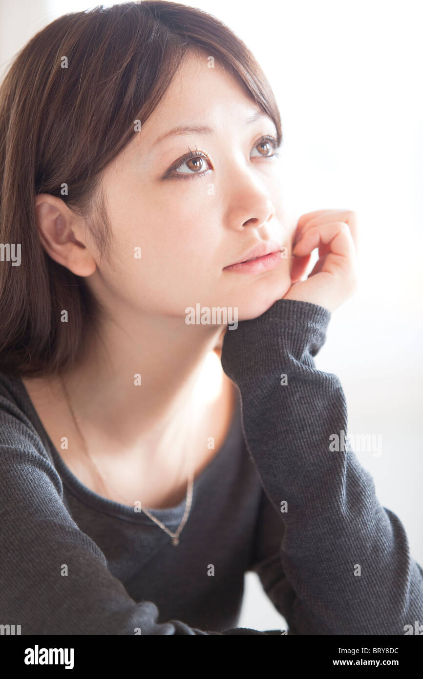 Young Woman Resting Her Chin in Her Hand Stock Photo Alamy