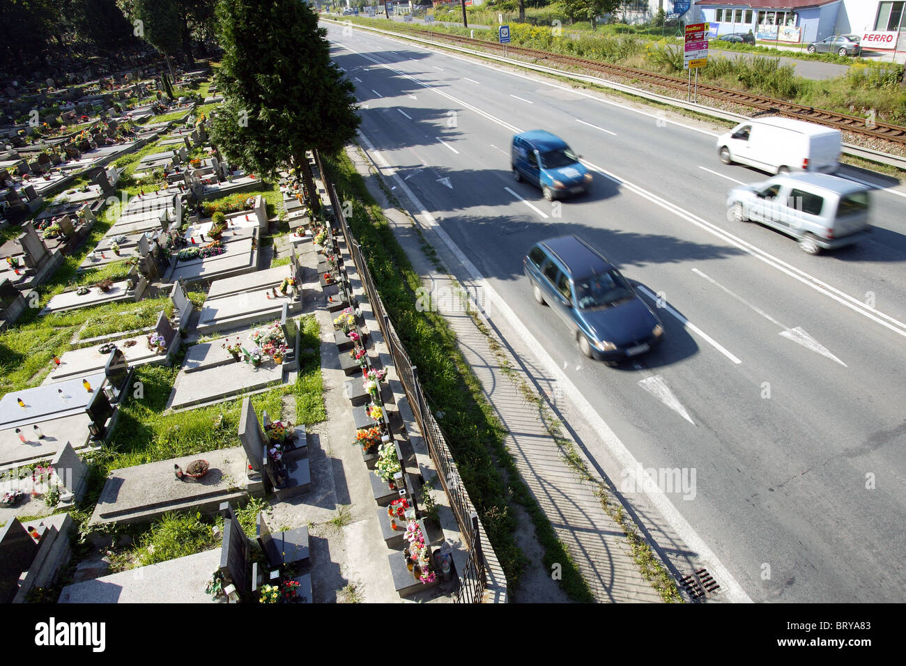 symbolic picture of traffic set against a cemetary Stock Photo