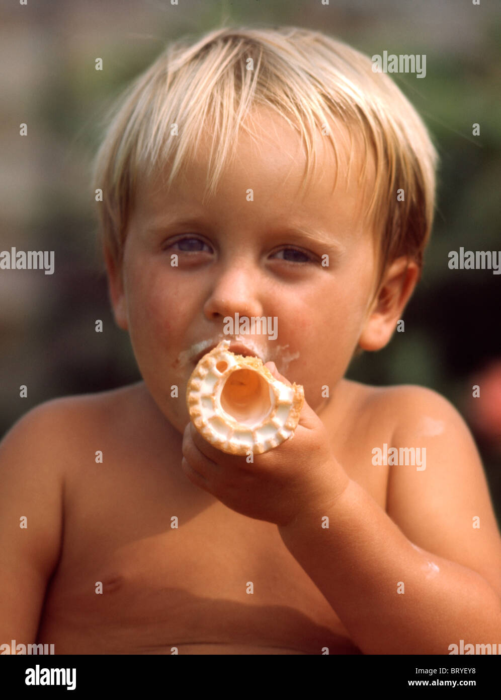 Boy sucking ice cream cone Stock Photo