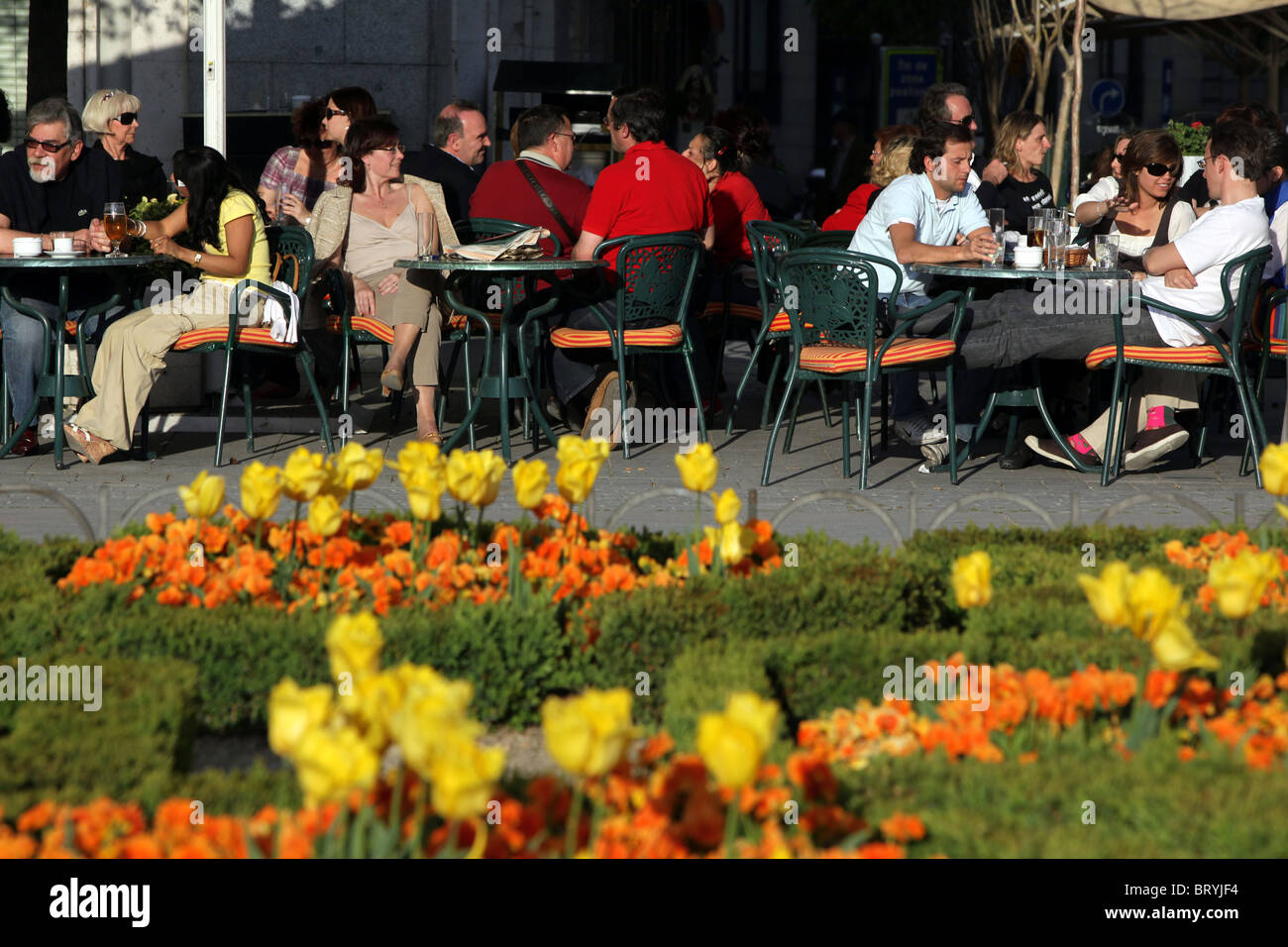 SIDEWALK CAFE AND PARTERRE OF FLOWERS, PLAZA ORIENTE, MADRID, SPAIN Stock Photo