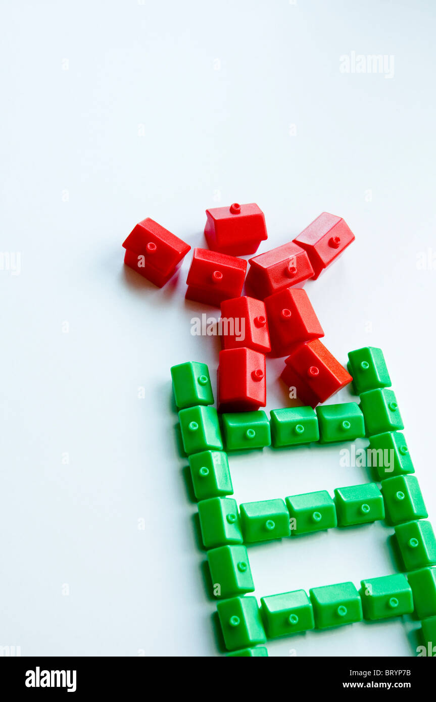 Property Ladder - Trading Up.  Monopoly green and red houses. Stock Photo