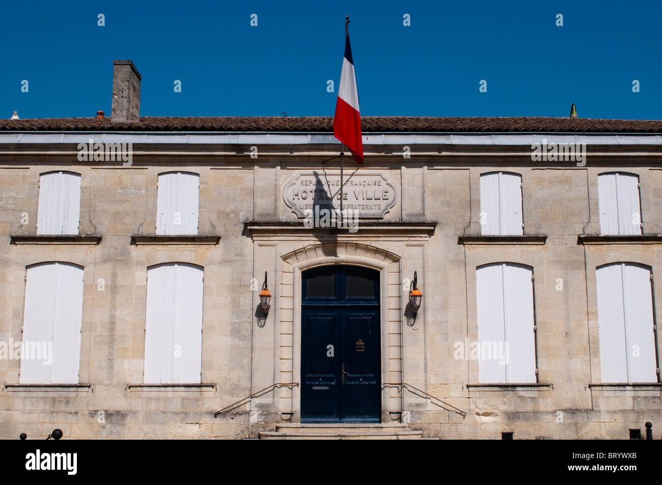 Hotel de Ville (Town Hall) with French flag, St Emilion, Bordeaux region, France Stock Photo