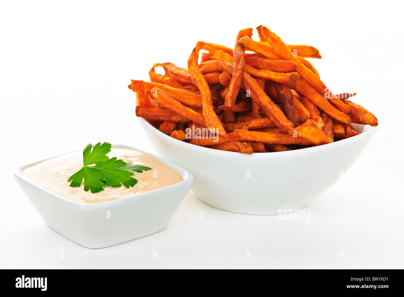 Bowl of sweet potato or yam fries with dipping sauce Stock Photo