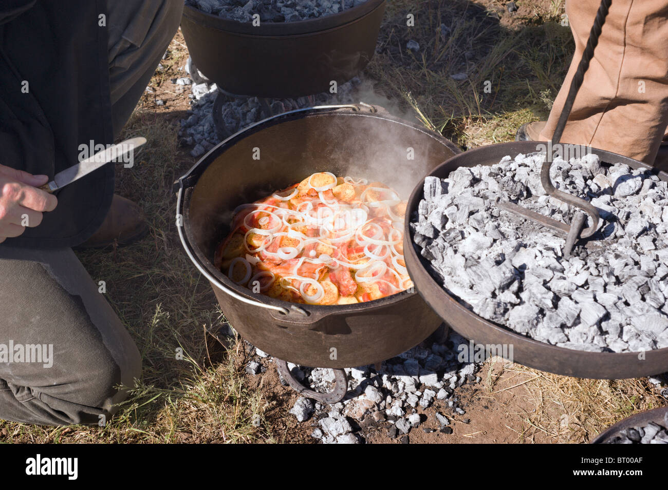 Cowboy cooking in a cast-iron kettle - Lincoln County Cowboy Symposium and Chuck Wagon Cook-Off, Ruidoso Downs, New Mexico. Stock Photo