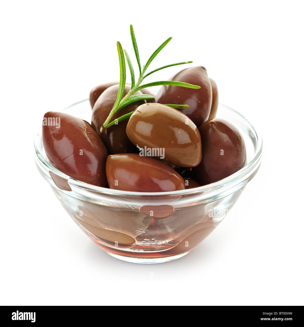 Kalamata olives in olive oil and herbs in bowl Stock Photo