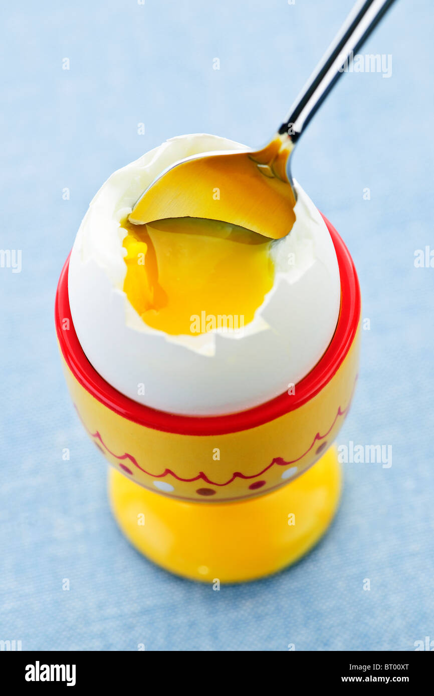 Closeup of soft boiled egg in cup with spoon Stock Photo - Alamy