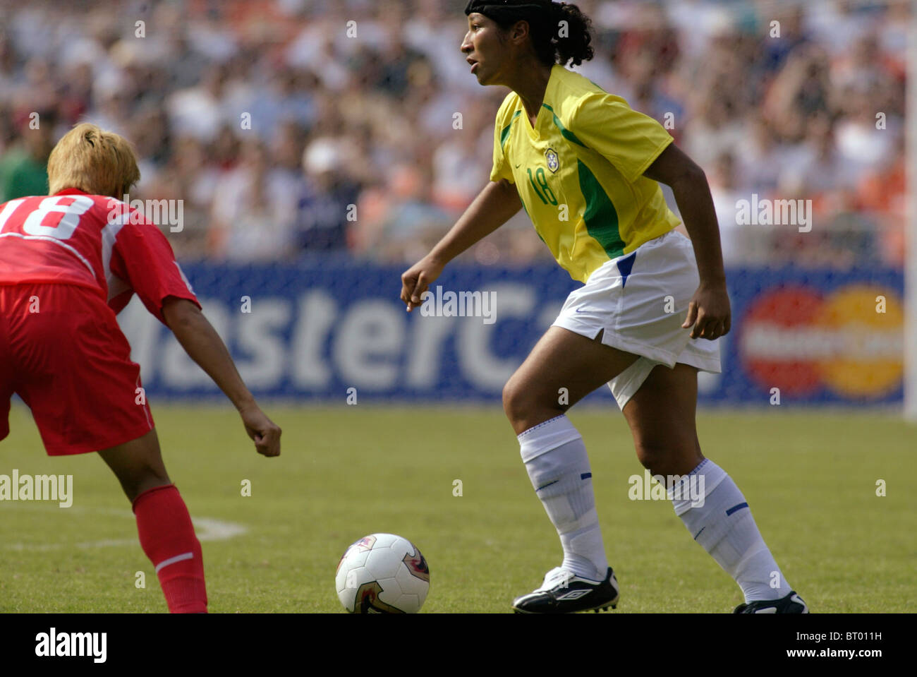 Daniela of Brazil (18) controls the ball against the Korea Republic during a 2003 Women's World Cup soccer match. Stock Photo