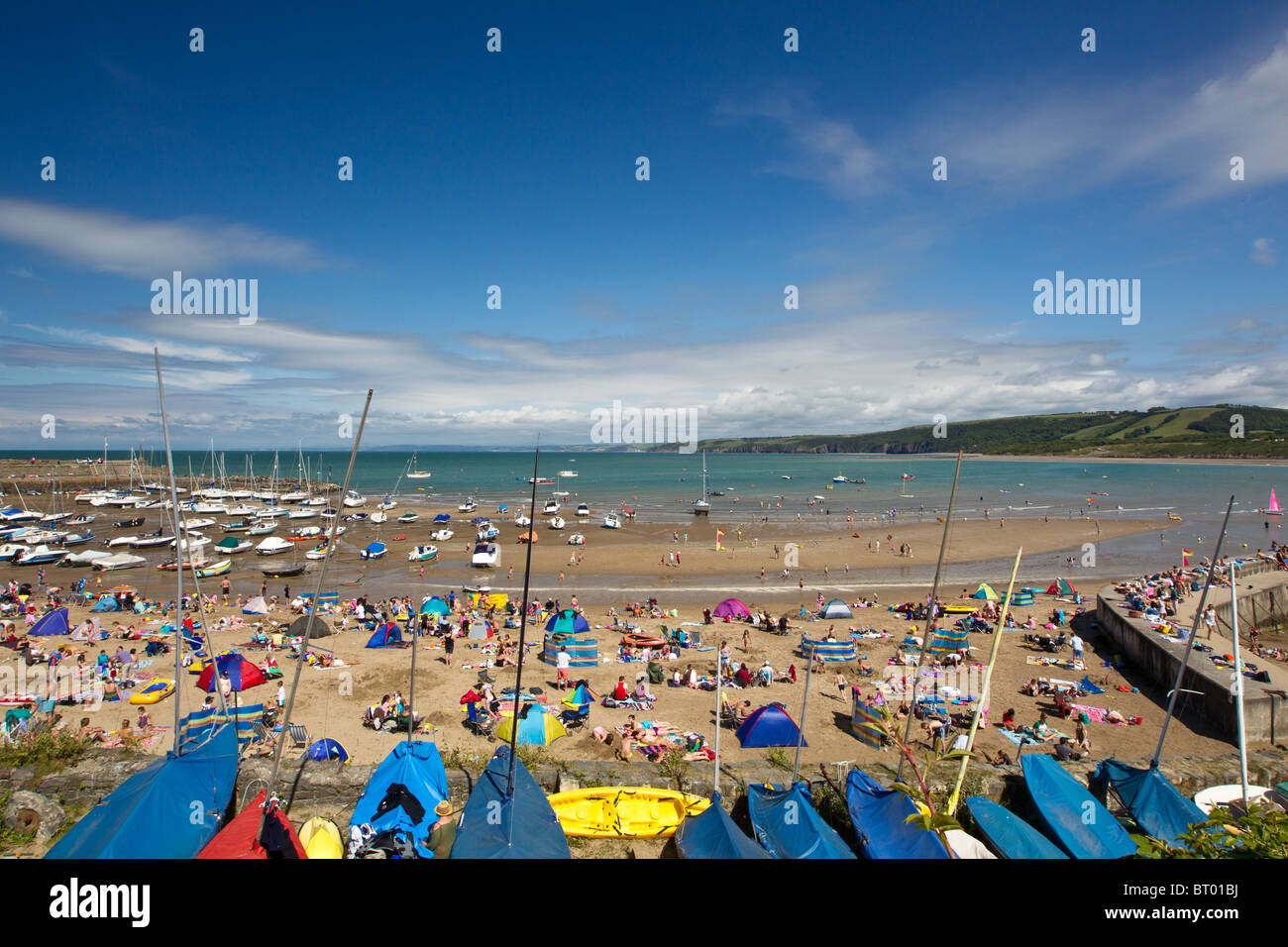 A packed New Quay Beach in Wales during British Summer time Stock Photo