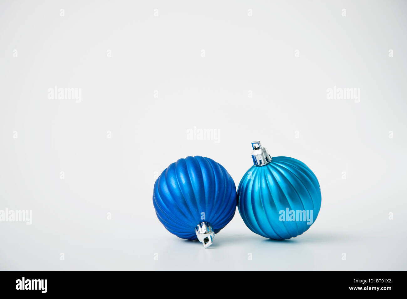 Two blue Christmas baubles Stock Photo