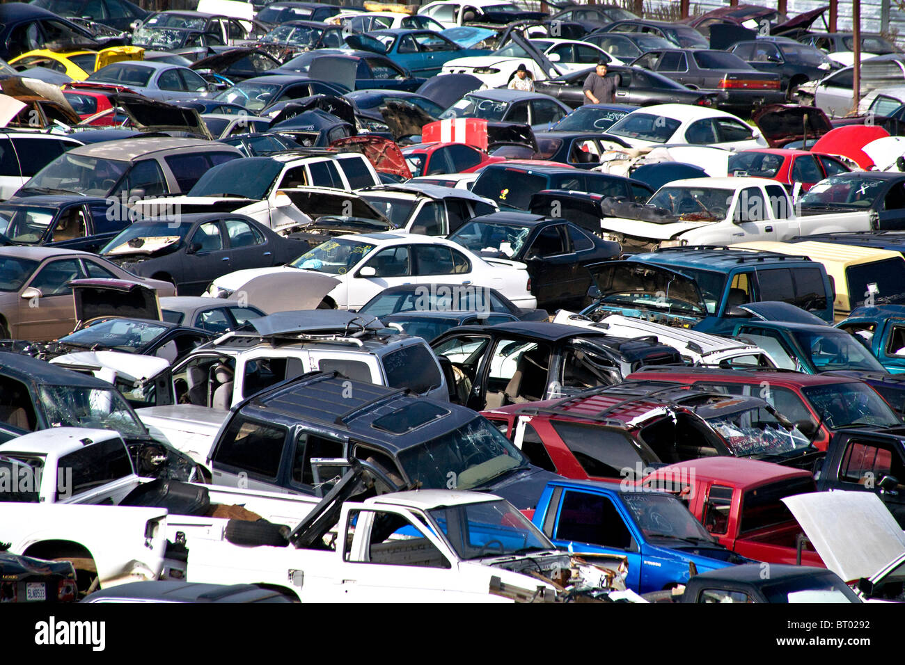 Old, abandoned automobiles are piled in an Atwater, CA, junk yard Stock