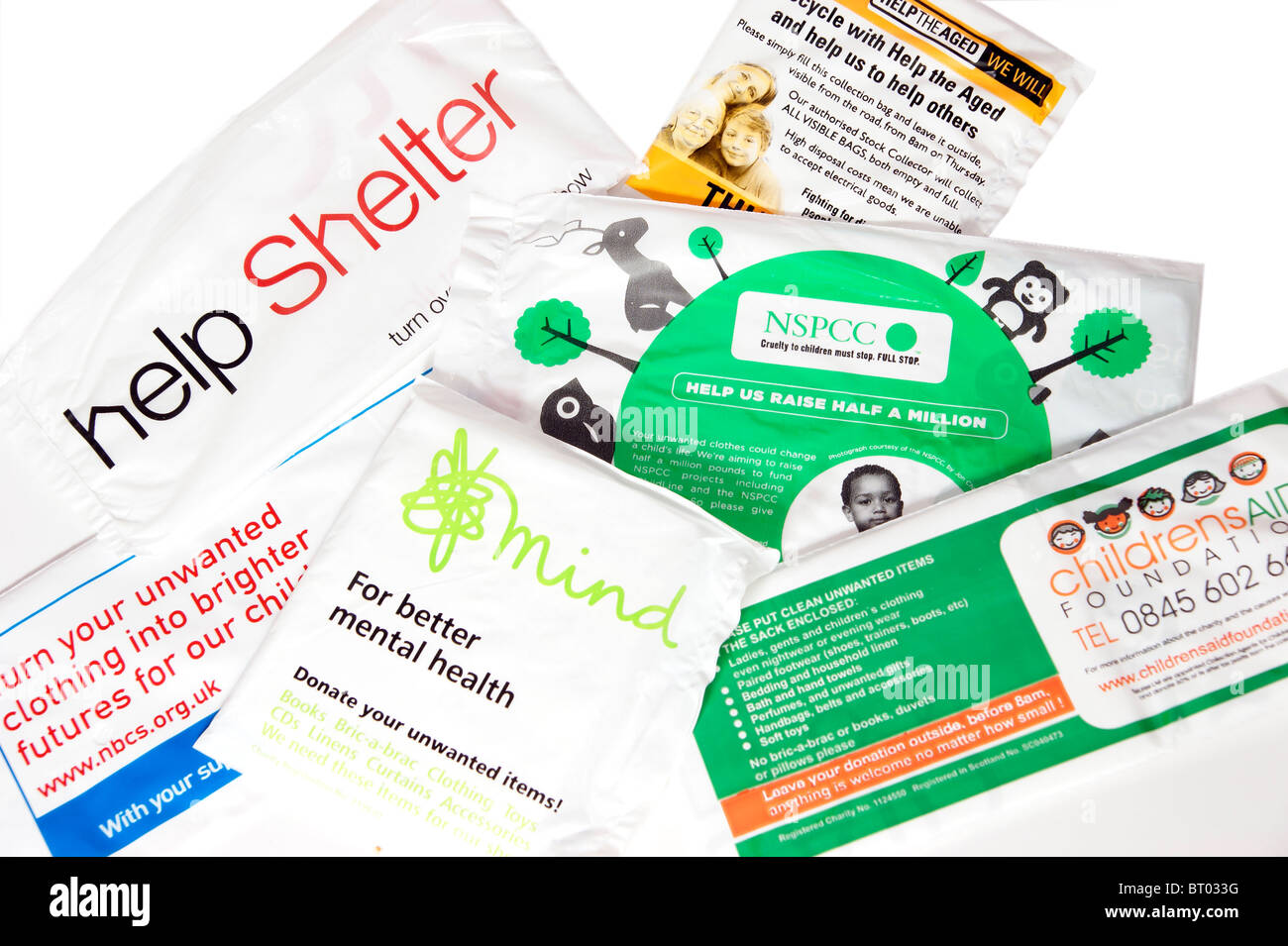 a mixture of charity collection bags - Help the Aged, National Blind Childrens Society, Shelter, Children's Aid, Mind & NSPCC Stock Photo