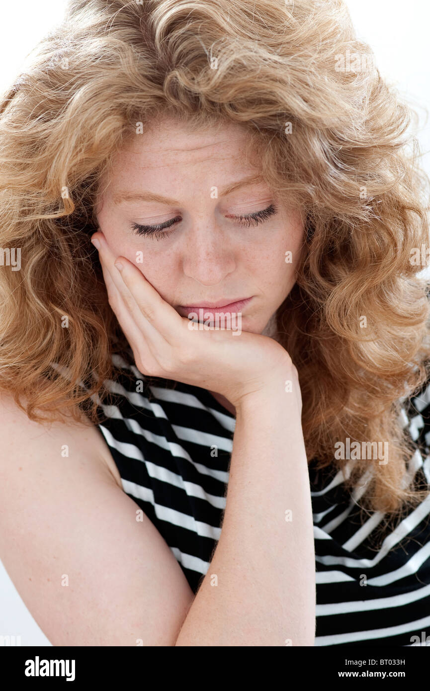 pensive woman  with hand on chin Stock Photo