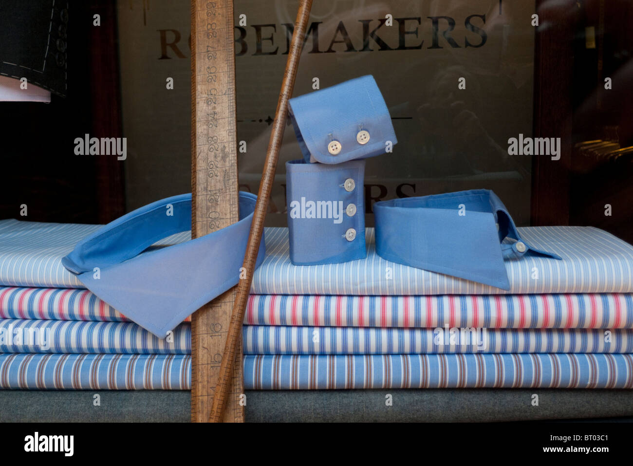 Collar, cuffs, striped shirt, yard stick and fabric in Ede and Ravenscroft window display Star Yard, London England UK Stock Photo