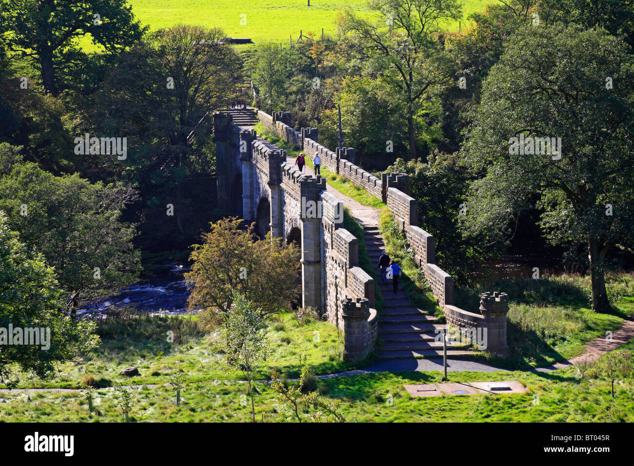 Walkers on Barden Bridge over the River Wharfe near Bolton Abbey, Yorkshire Dales National Park, North Yorkshire, England, UK. Stock Photo