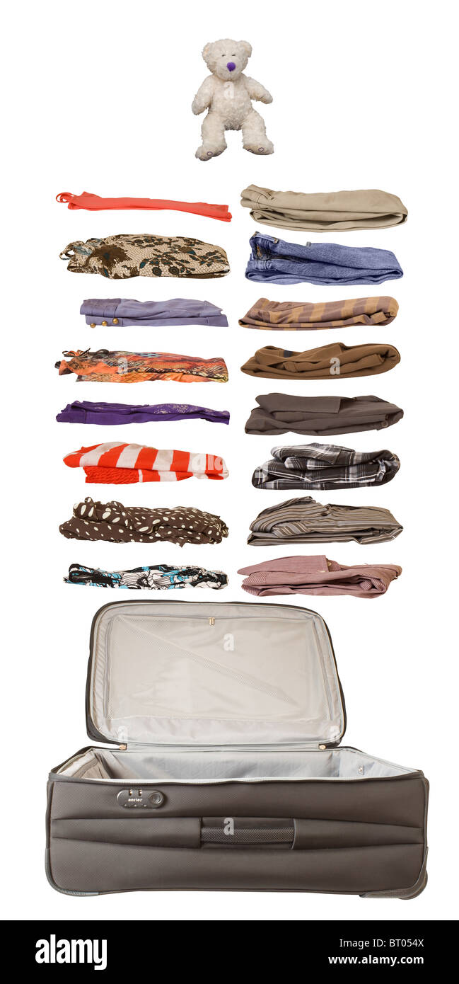 An open suitcase with a selection of folded male and female clothes and a toy bear representing personal items that may be packed Stock Photo