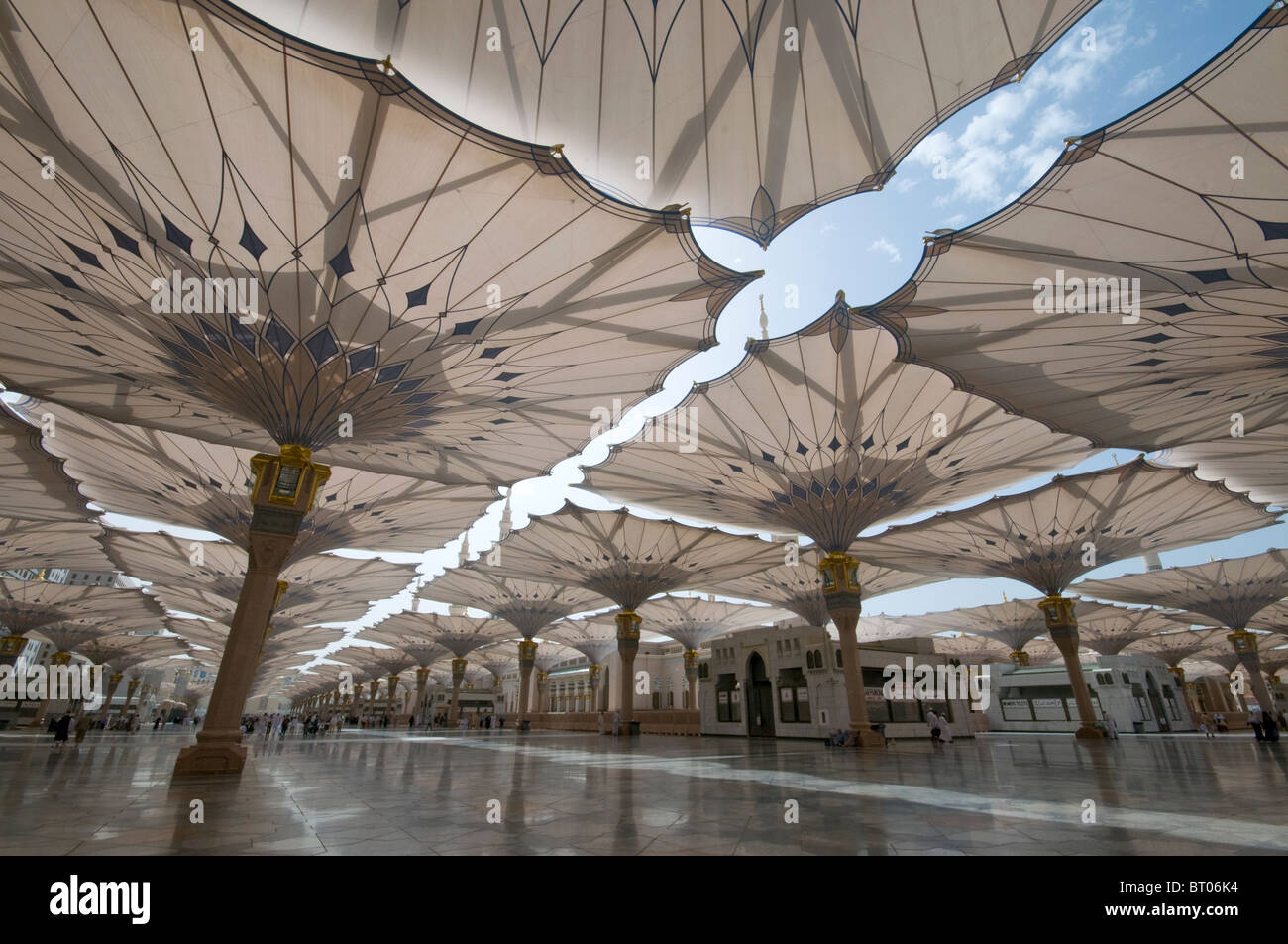 Pilgrims walk underneath giant umbrellas at Nabawi Mosque compound on