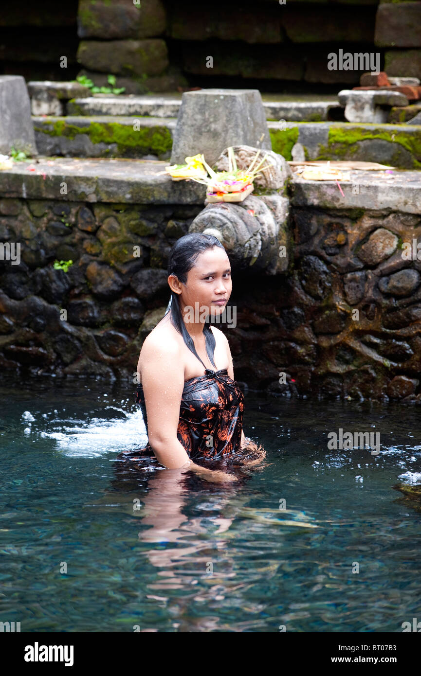 Bathing in the holy waters at Tirta Empul Temple, Tampak Siring Village, Bali, Indonesia Stock Photo