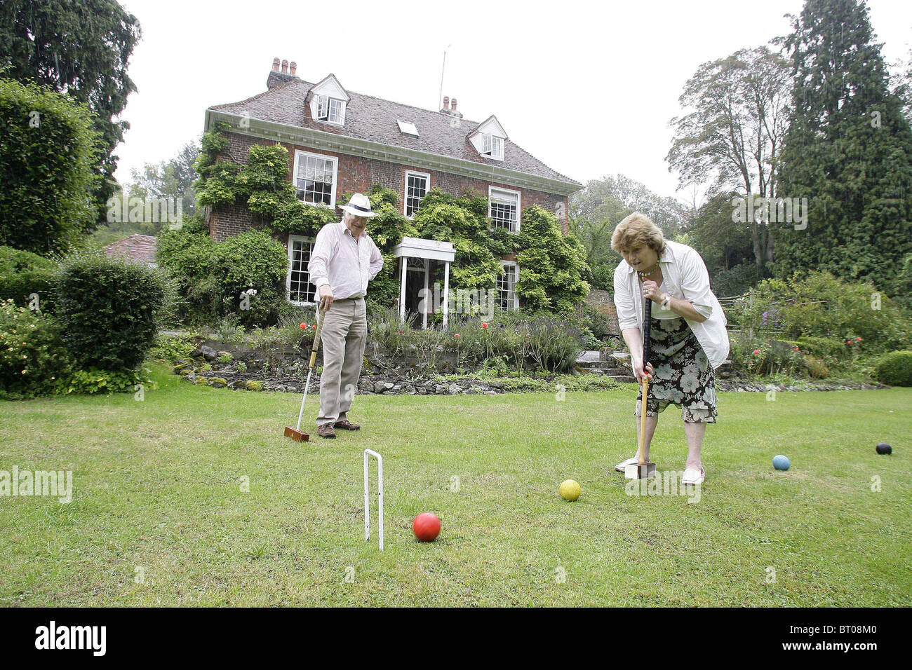Tony and nplaying croquet at there Bed and Breakfast 'Vale House' Stock Photo