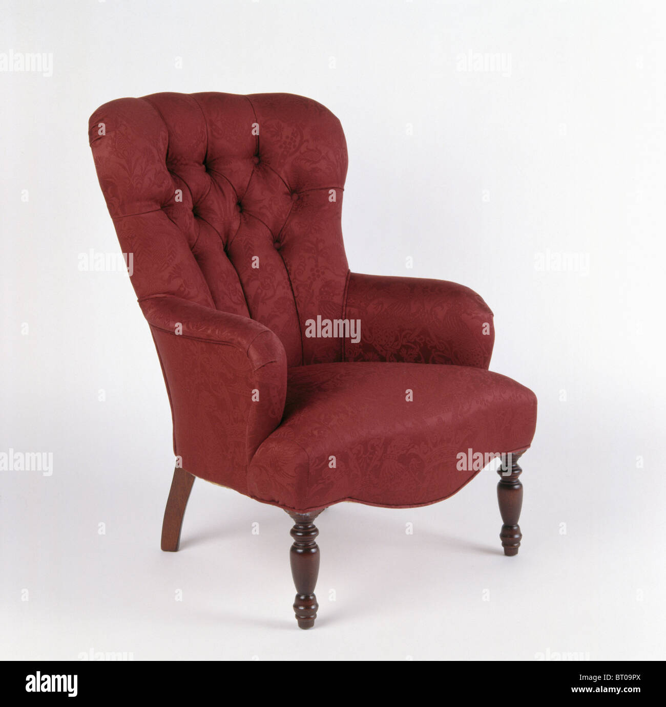 Close Up Of Dark Red Victorian Style Button Back Armchair Stock