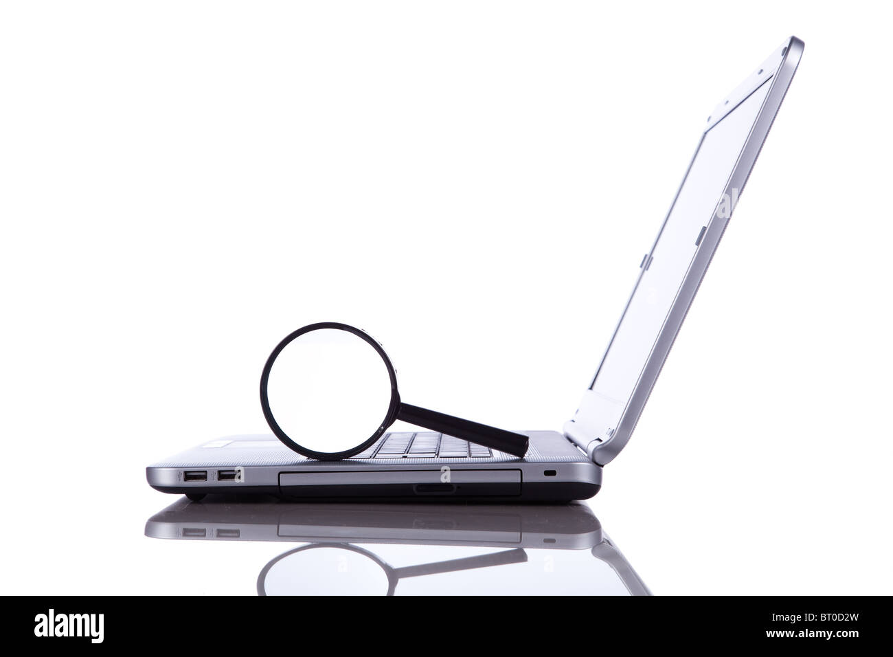 Laptop with a magnify glass to search online information (isolated on white) Stock Photo