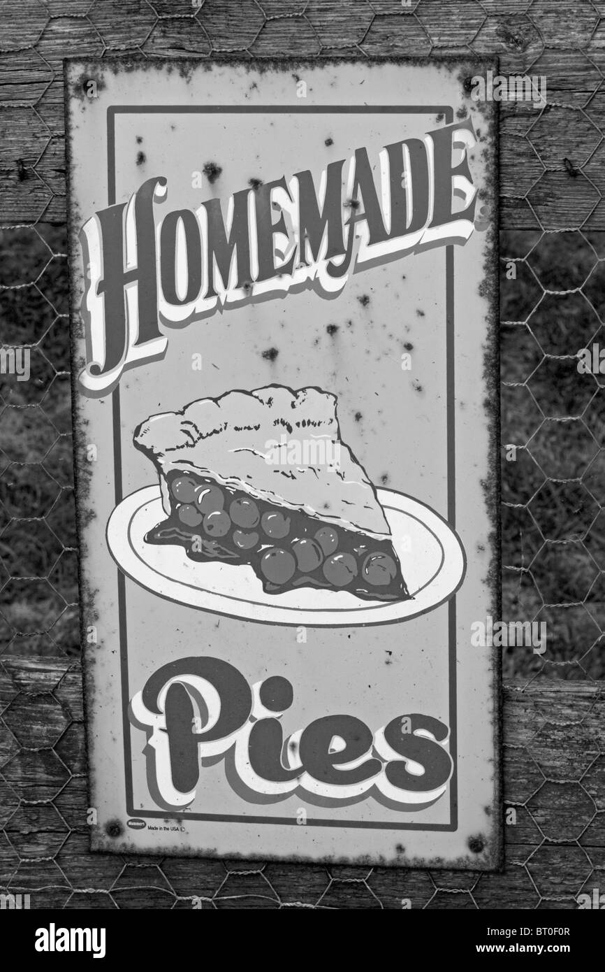 Old and weathered metal sign advertising homemade pies. Black and white. Stock Photo