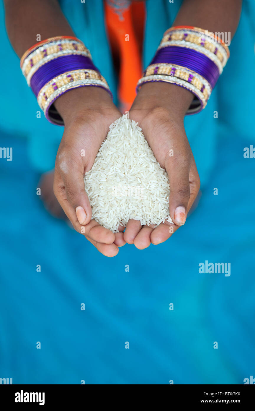 Indian girl holding uncooked rice in her cupped hands. India Stock ...