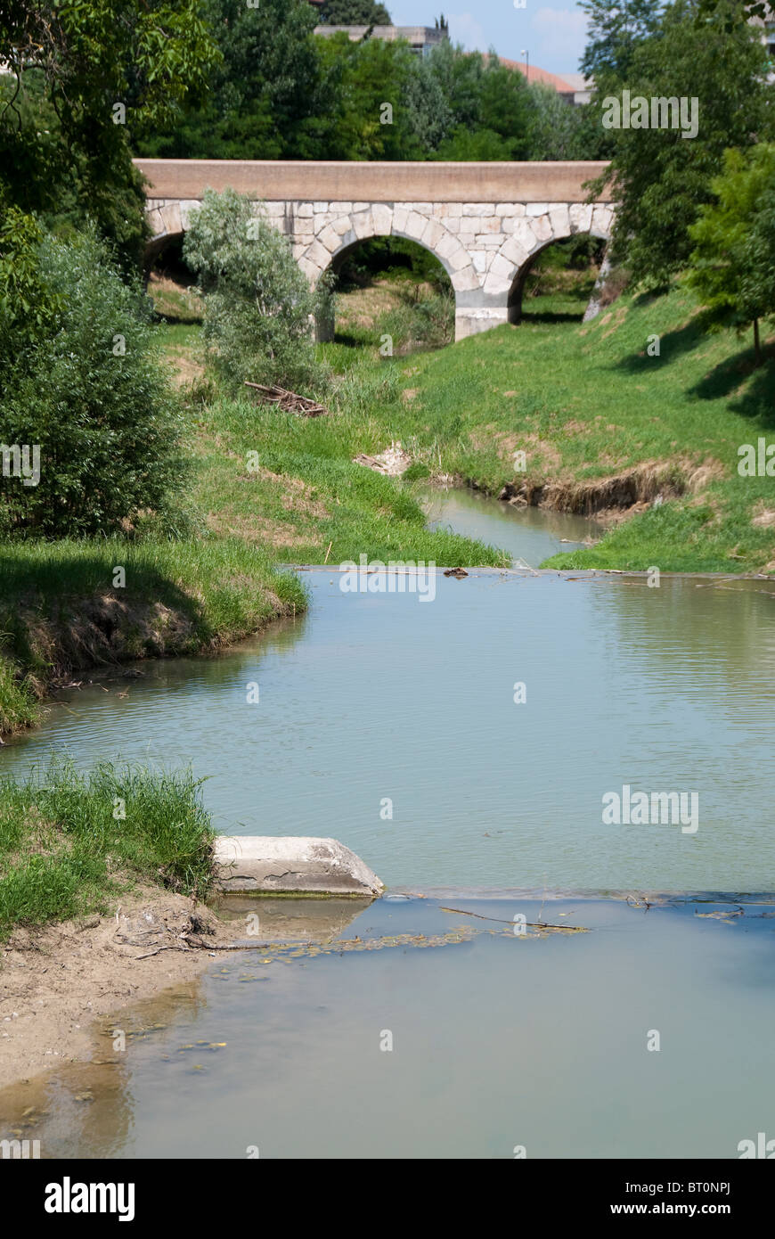 The bridge over the Rubicon River where Julius Caesar crossed the boundry of the Roman Republic in 49BC Stock Photo