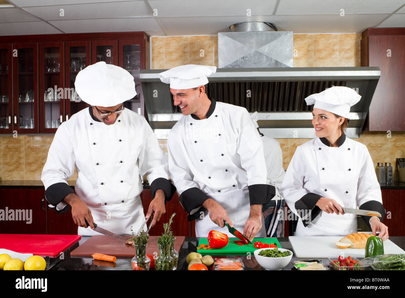 group of professional chefs cooking in industrial kitchen Stock Photo