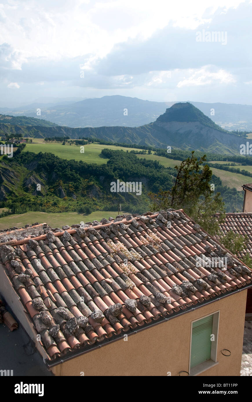 Panorama across the roofs of houses in the fortress town of San Leo, to the Appenine mountains of Le Marche. Stock Photo