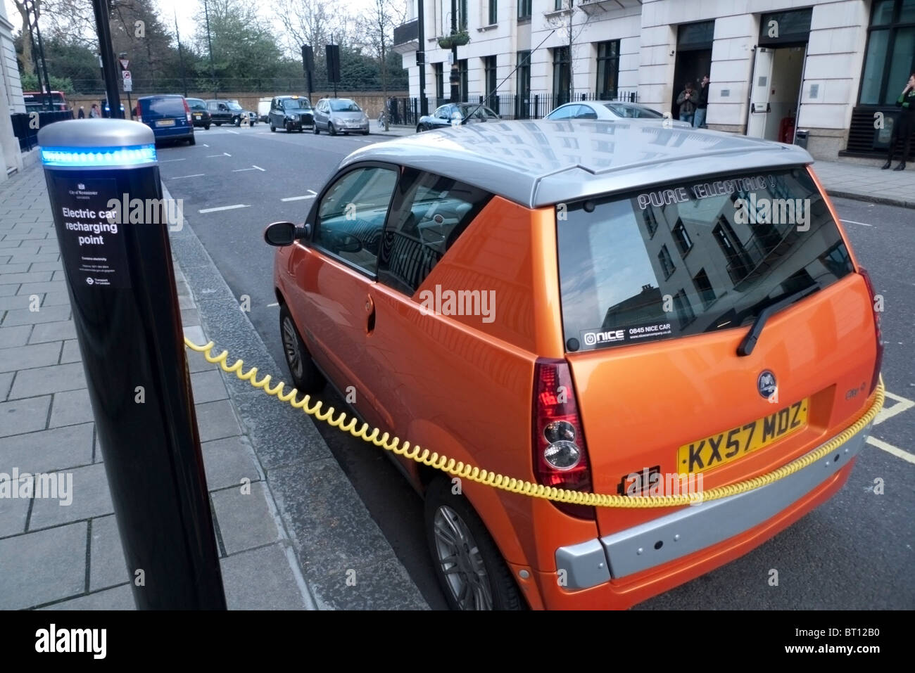 A low emissions fuel efficient electric car charging power at a charging point station in London