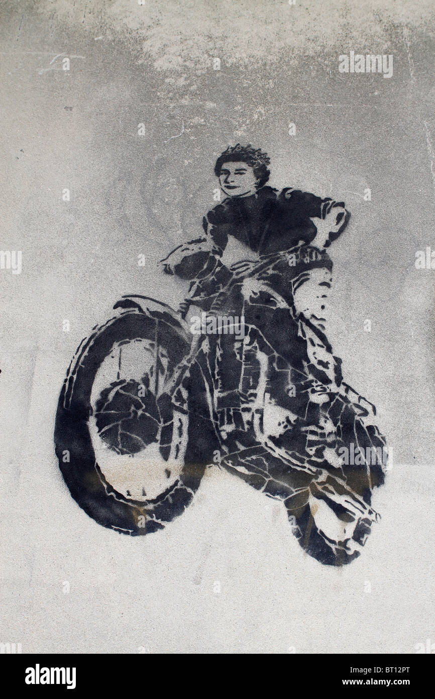 McQueen stencil greffiti, Queen Elizabeth 2nd motorbike jump from the great escape movie, street art London, UK Stock Photo