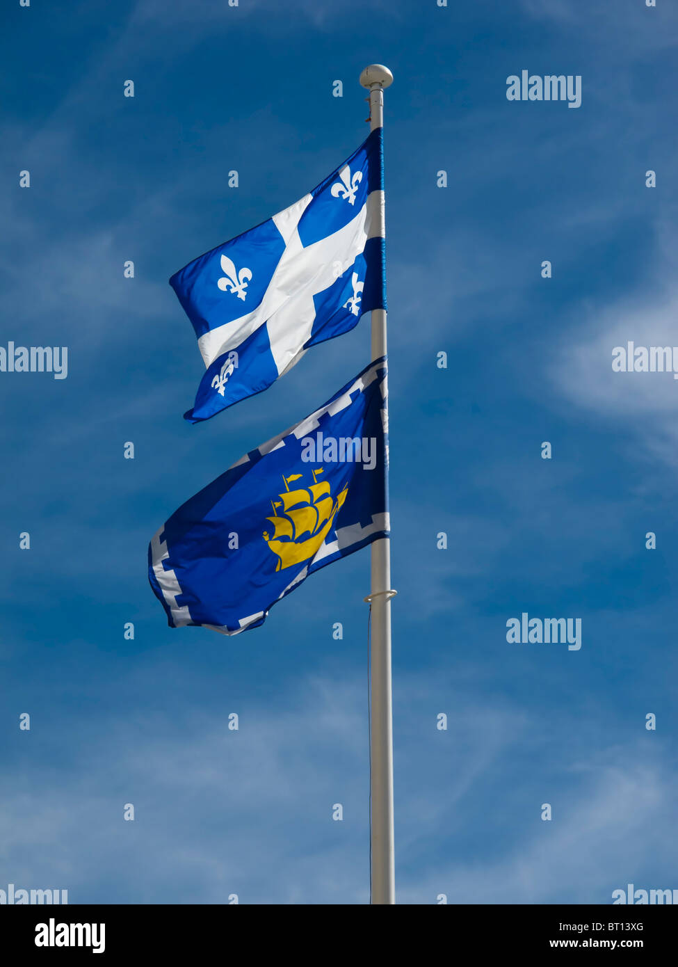 A flagpost at the entrance to the port of La Rochelle in France, on top a white cross on blue background and Fluer de Lys Stock Photo