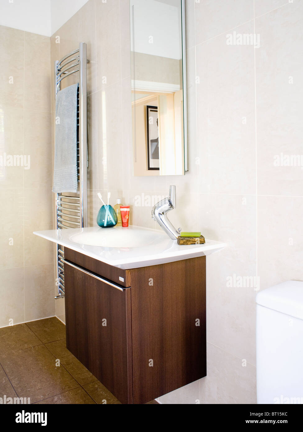 Mirror Above Basin In Dark Wood Vanity Unit In Modern White Bathroom Stock Photo Alamy