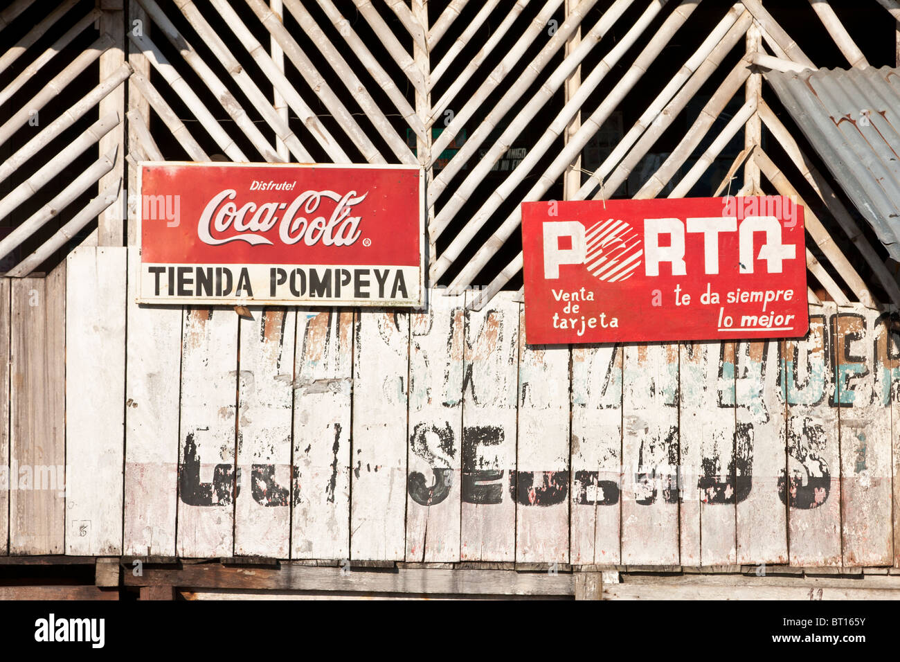 Advertising signs on old wooden shop building, Napo, Ecuador Stock Photo
