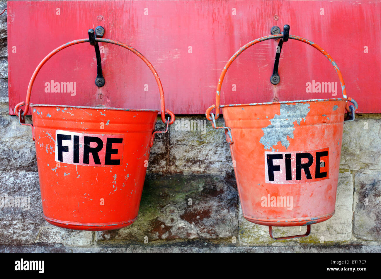two bright red emergency fire buckets hanging at corfe railway station