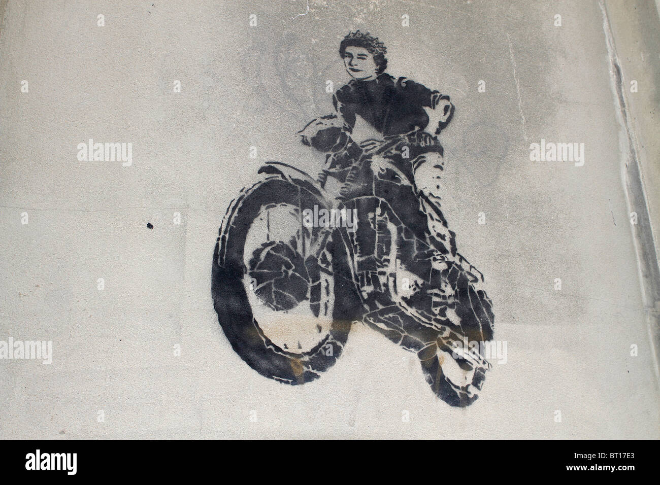 McQueen stencil greffiti, Queen Elizabeth 2nd motorbike jump from the great escape movie, street art London, UK Stock Photo