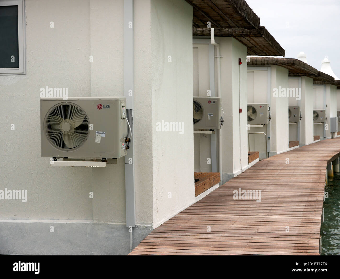 LG Air conditioning units on walls of water bungalows in Indian ocean Stock Photo