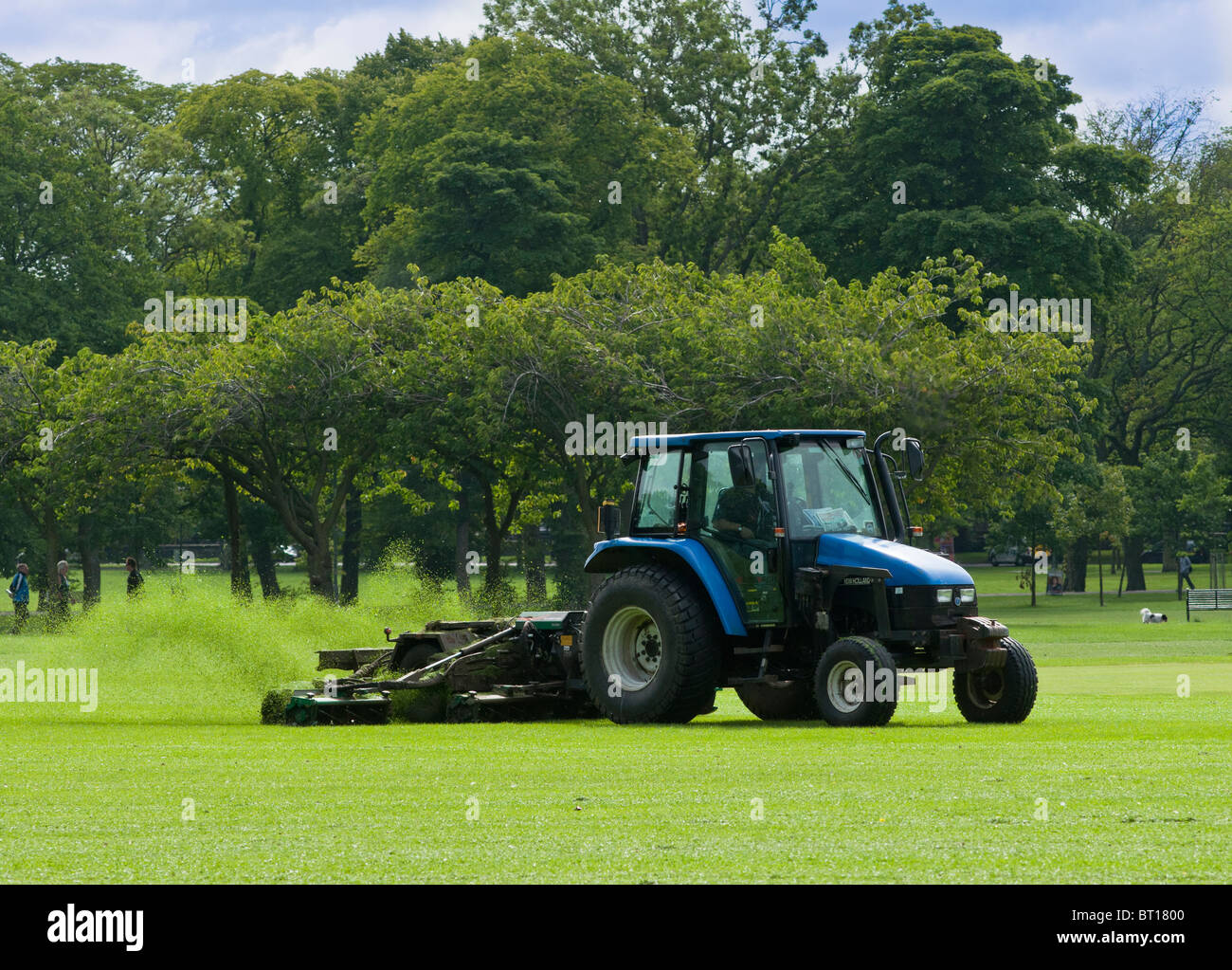 A tractor cuts the grass at West Meadow park, Edinburgh Stock Photo