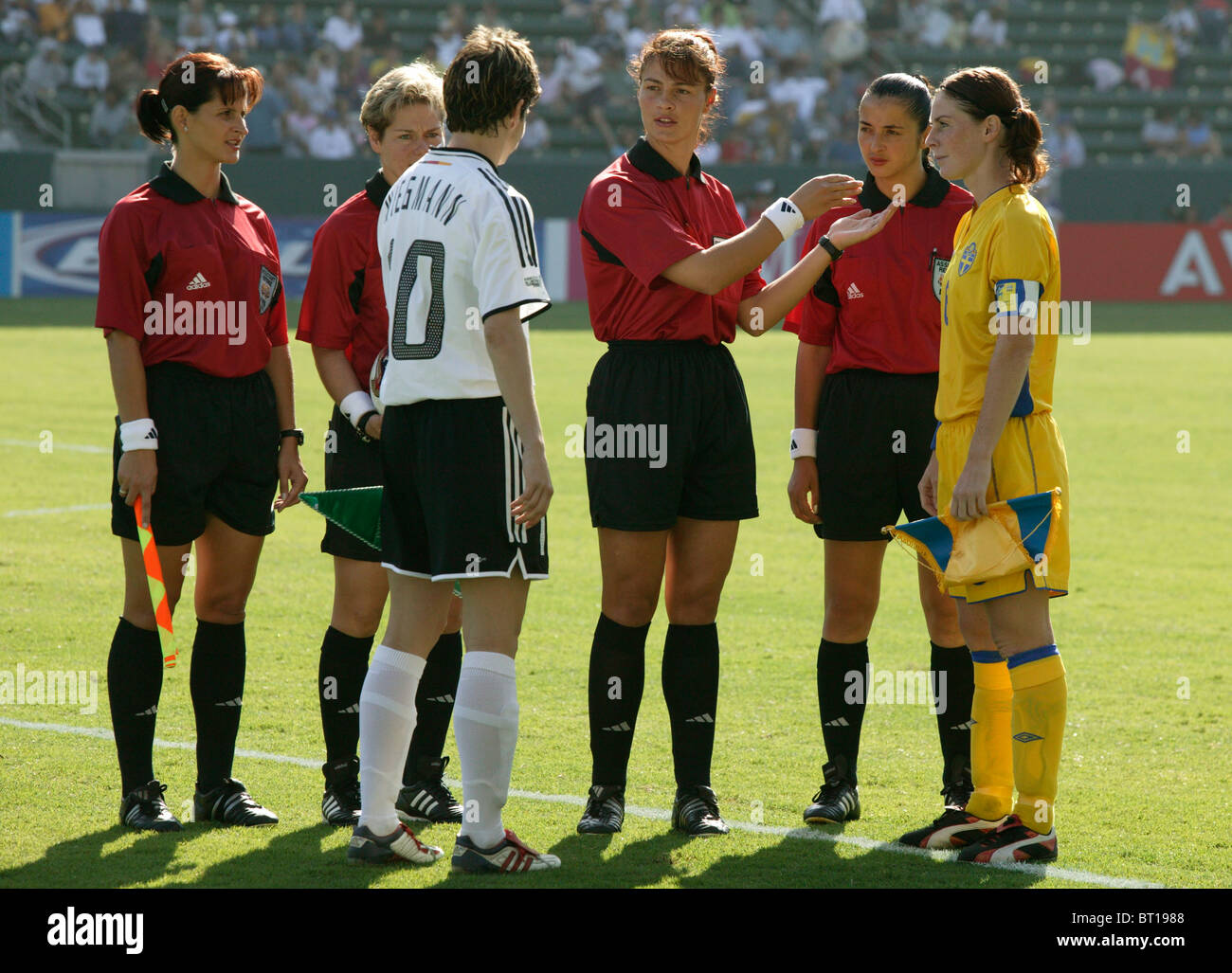 Referee Cristina Babadac discusses the coin toss with Bettina Wiegmann (l) and  Malin Mostrom (r) at the 2003 World Cup final. Stock Photo