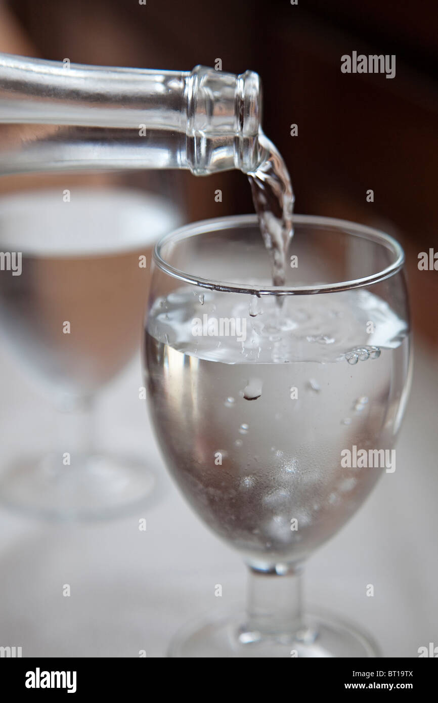 Vaso de agua y botella Glass of water and bottle Stock Photo