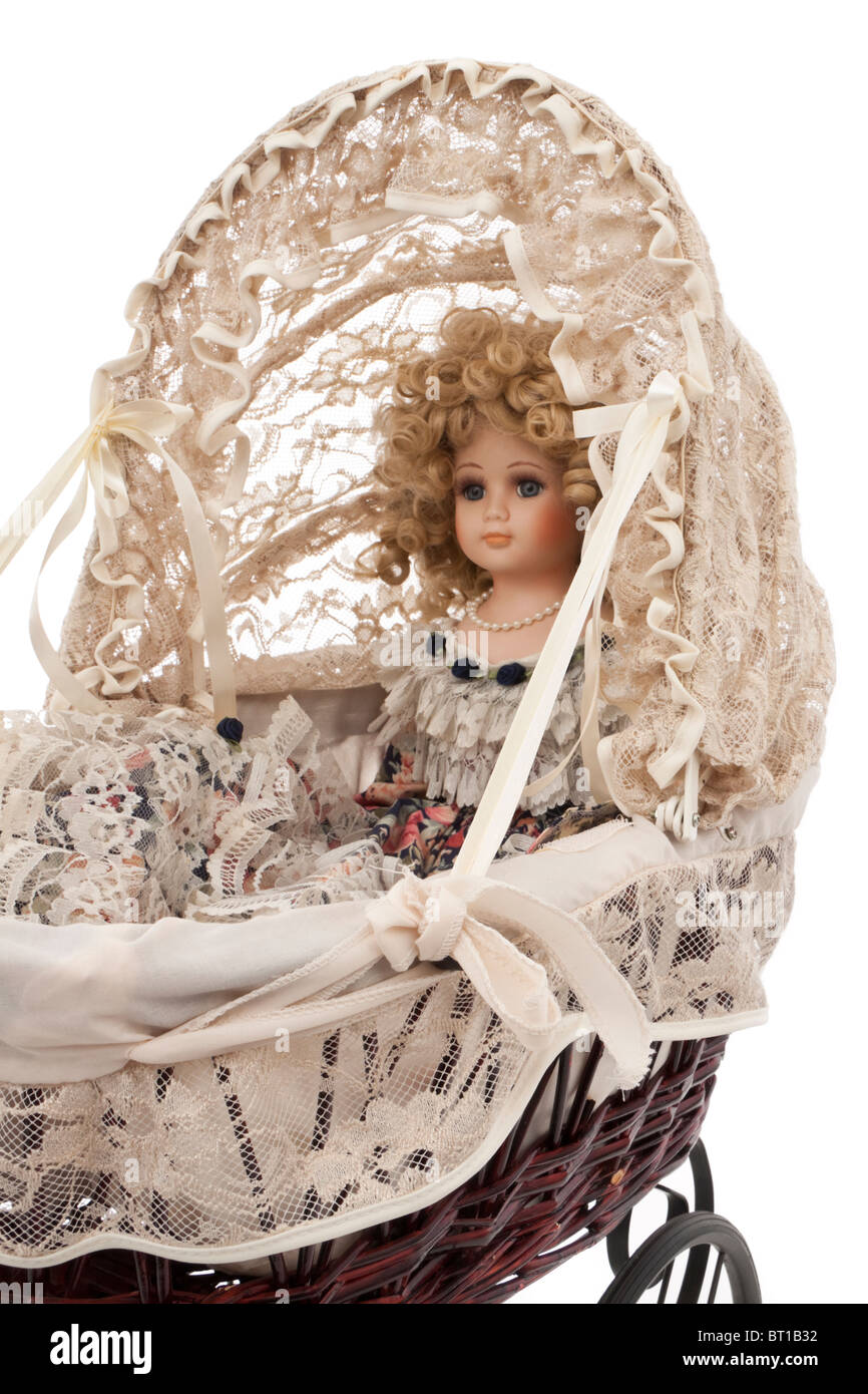 Reproduction antique Victorian dolls pram with lace hood and doll inside Stock Photo