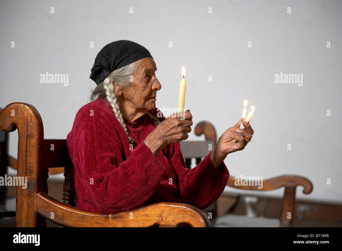 Painet kc4710 woman female women females guatemala holding candles in church of chajul el quiche central america latin Stock Photo