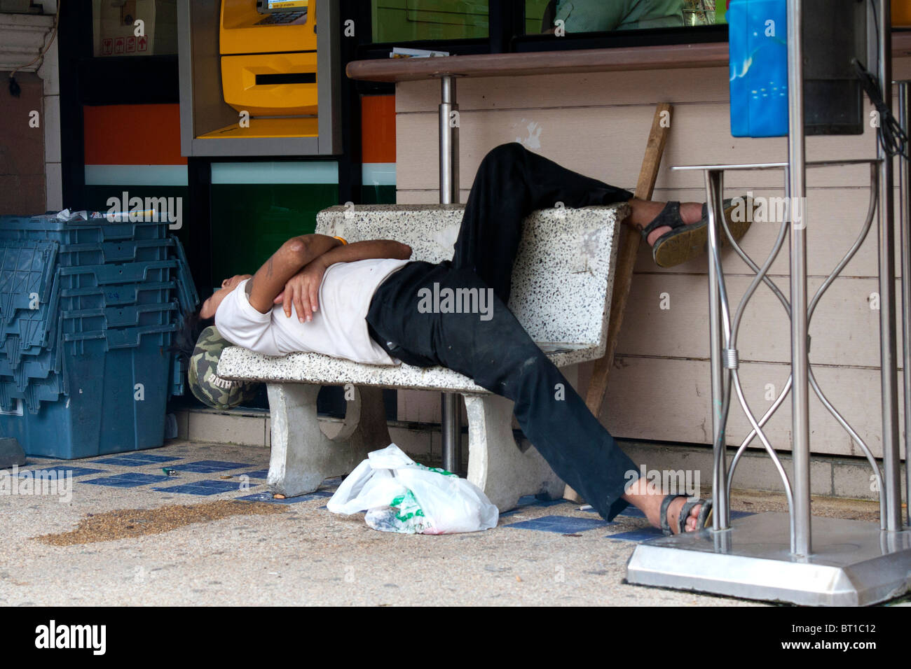 man sleeping on a bench Stock Photo - Alamy