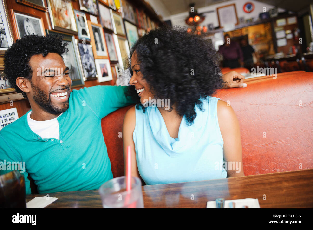 Couple sitting in restaurant booth hires stock photography and images