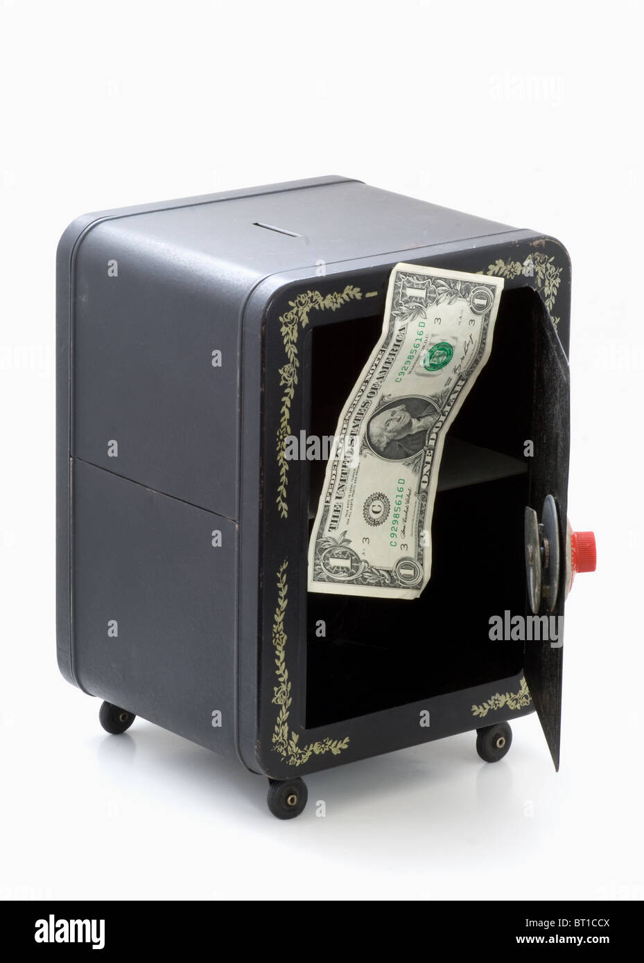 Last dollar out from toy bank safe with door open. Dollar floating up. Stock Photo