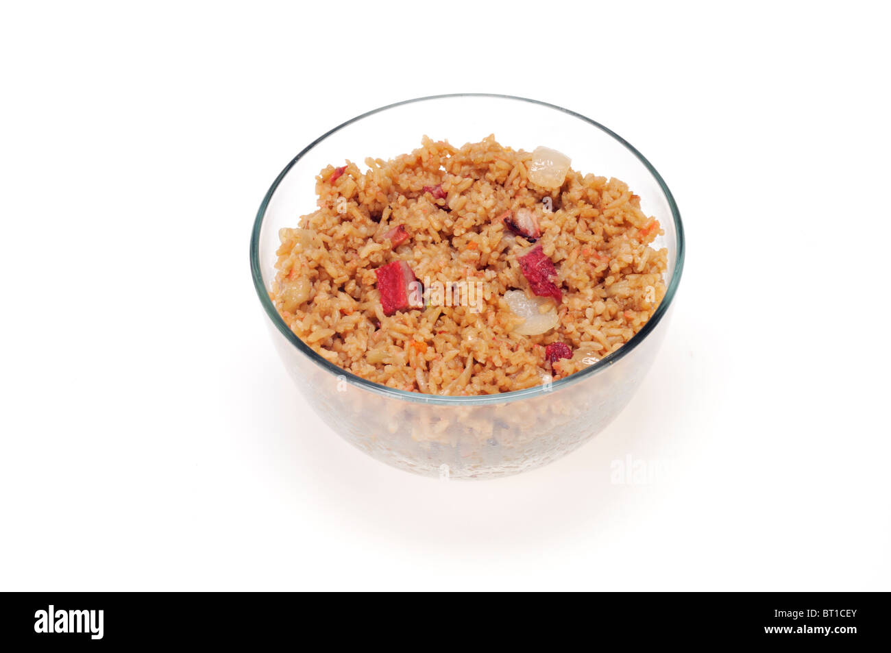 Glass bowl of cooked Chinese pork fried rice on white background cut out. Stock Photo