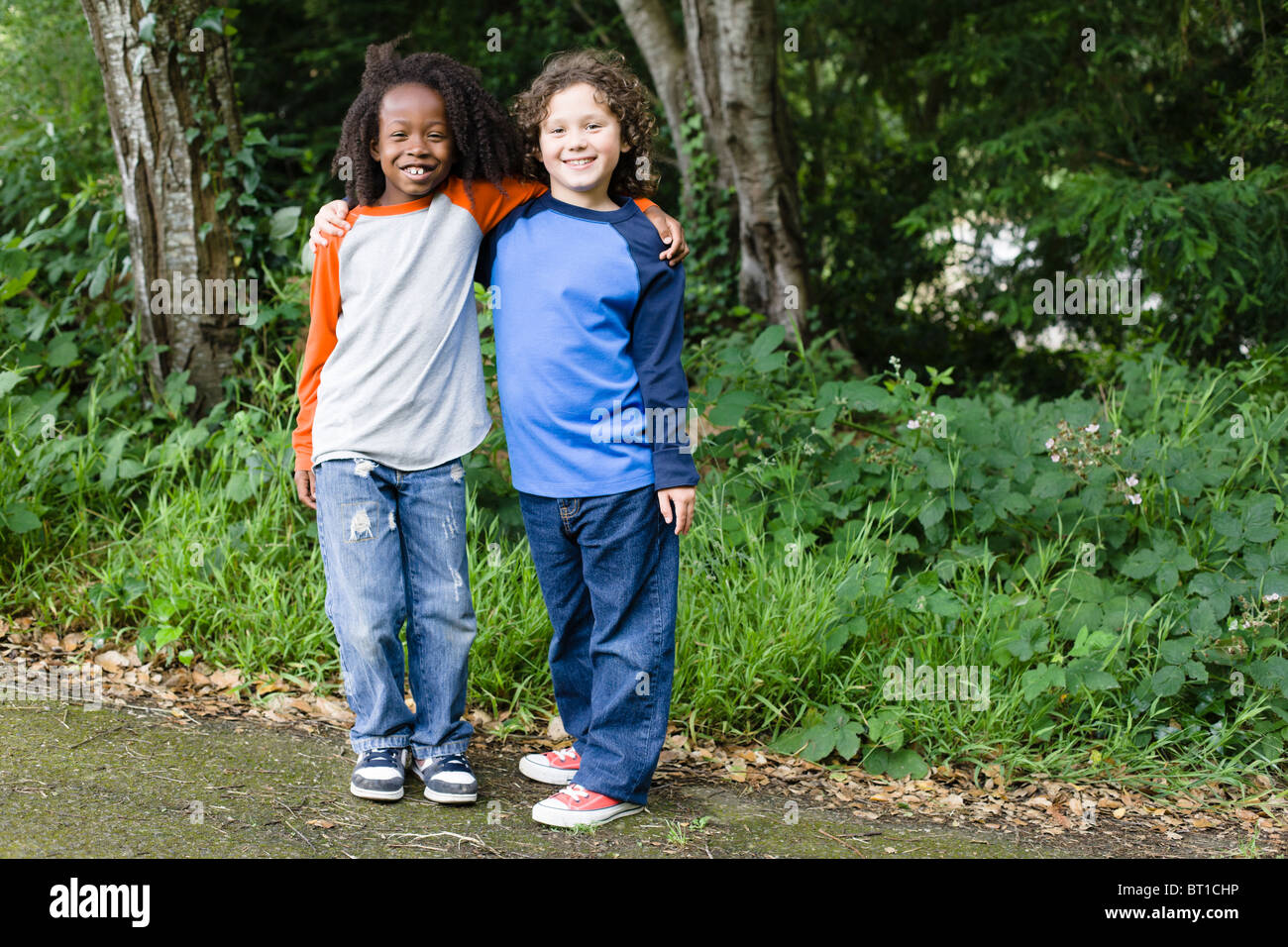 Smiling friends in park Stock Photo - Alamy