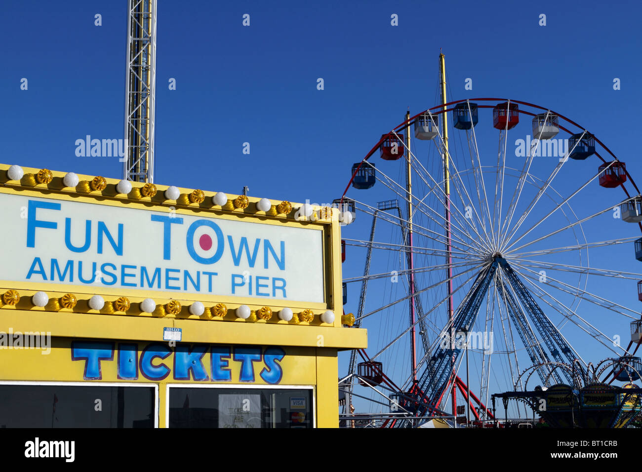 Seaside Heights Fun Town Amusement Pier ticket booth with ferris wheel in the background. Seaside Heights, New Jersey, USA. Stock Photo