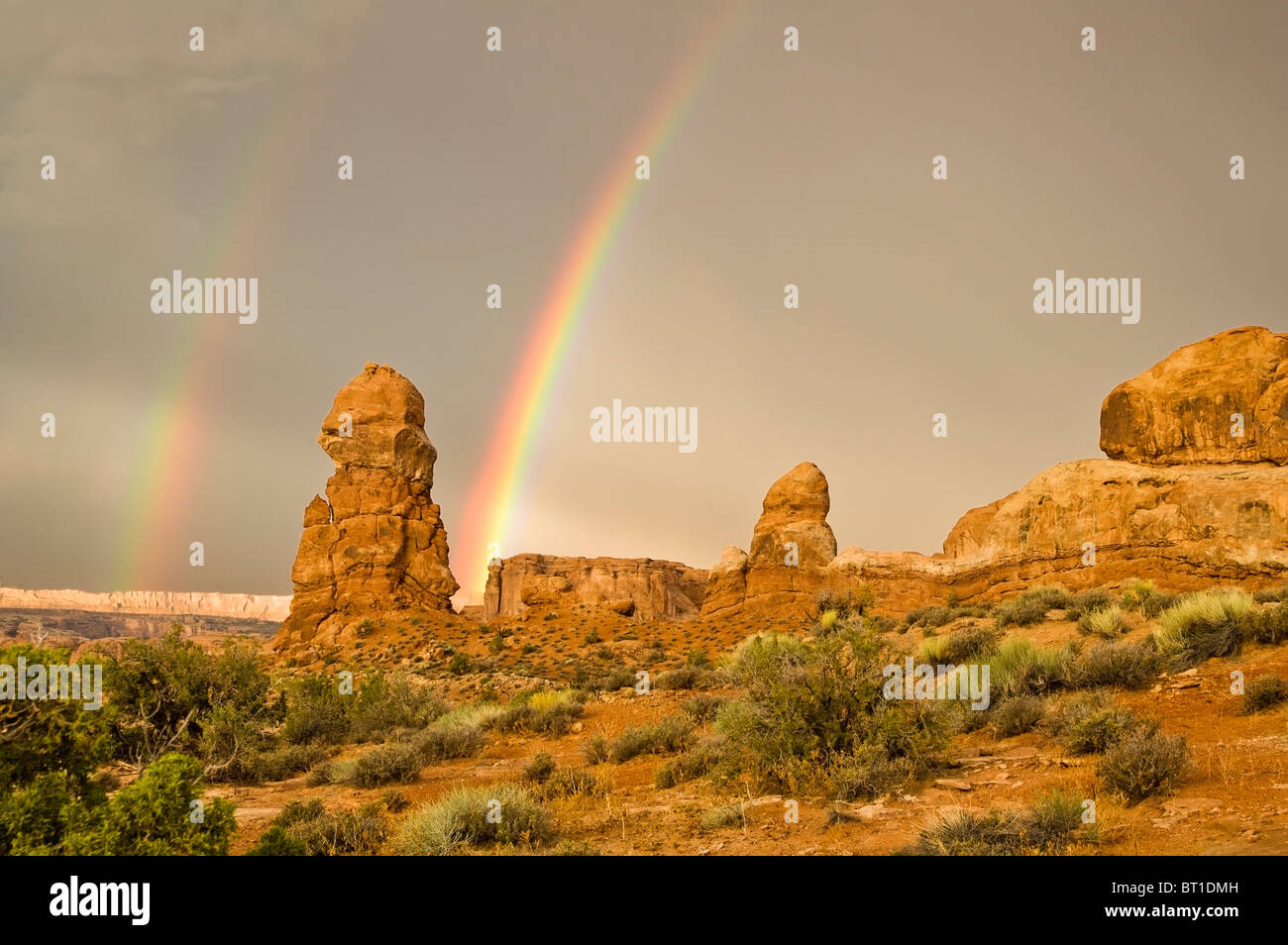 A double rainbow appears after a rainstorm passes over the sandstone ...