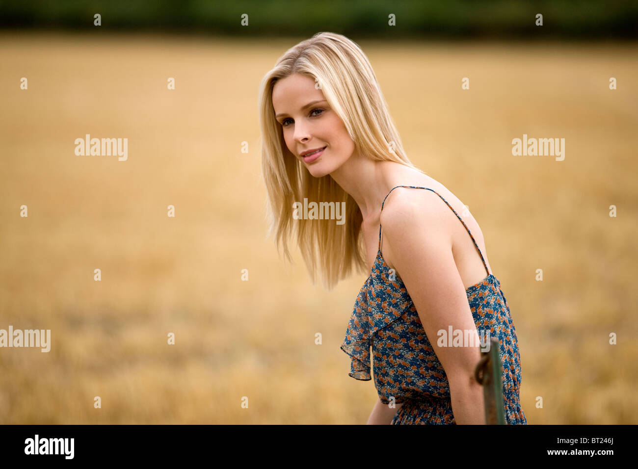A portrait of a blonde haired woman in a wheatfield Stock Photo